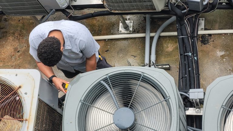 Young HVAC technician has modern equipment in technology working on A/C system in Brooks, GA