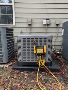 HVAC techs work on heat pump and refrigerant leaks
